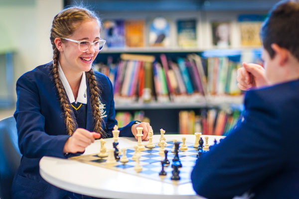 Two students at Clancy Catholic College West Hoxton playing chess in the library